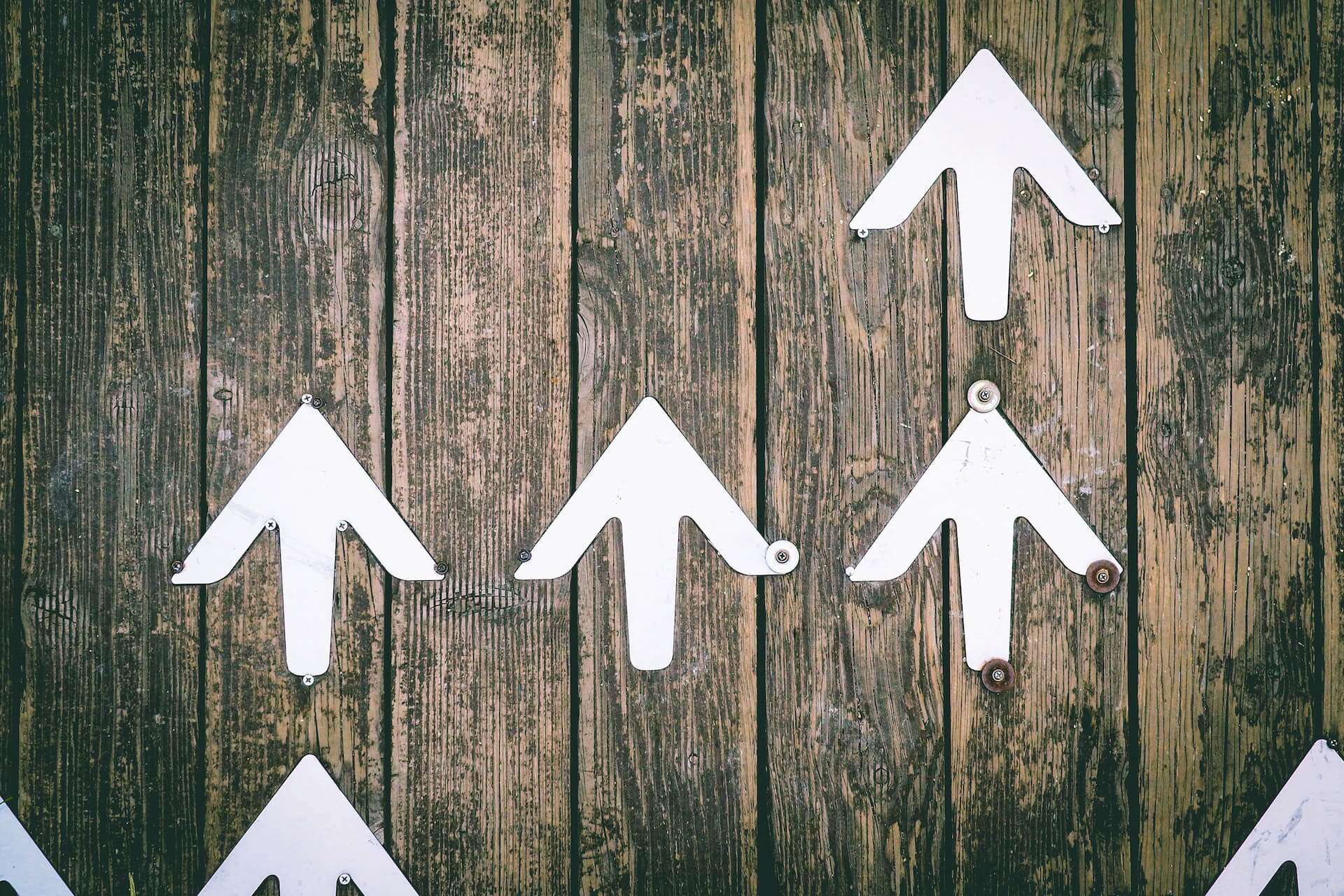 White arrows on wood - Why a great marketing strategy stops you making bad decisions