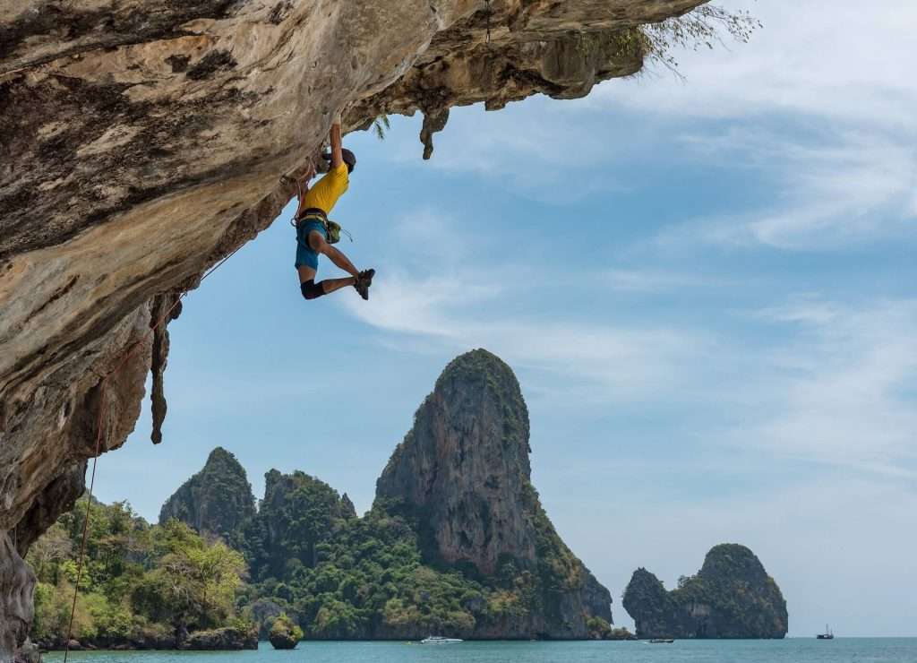 CIO climber hanging from rock face