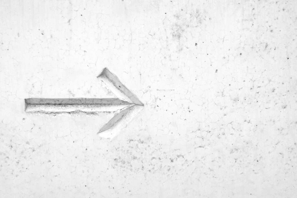 Brand Strategy white arrow engraved in white marble