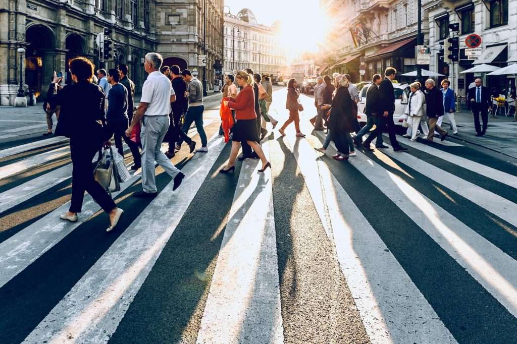 A crowd crossing a cross walk.
