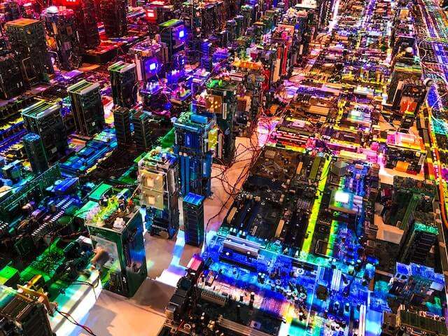 Aerial photo of a colourful, lit up electric circuit that looks like a cityscape. Image for Employer Value Proposition Blog.