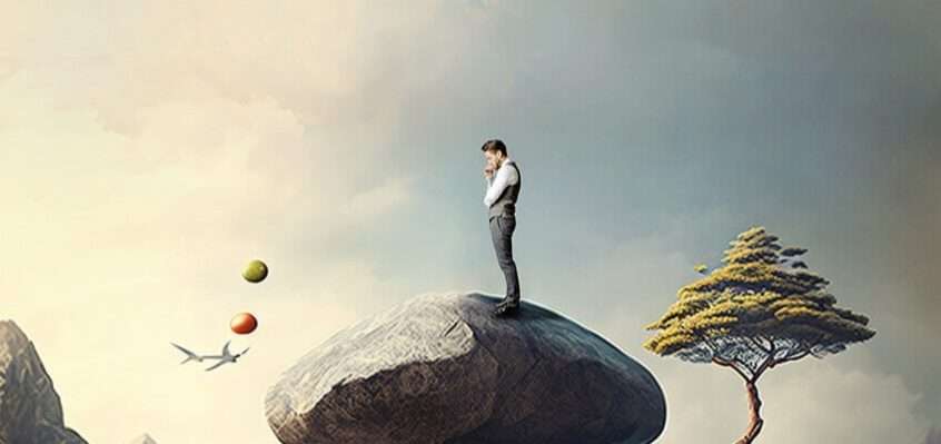 A man standing on top of a rock surrounded by deep growth.
