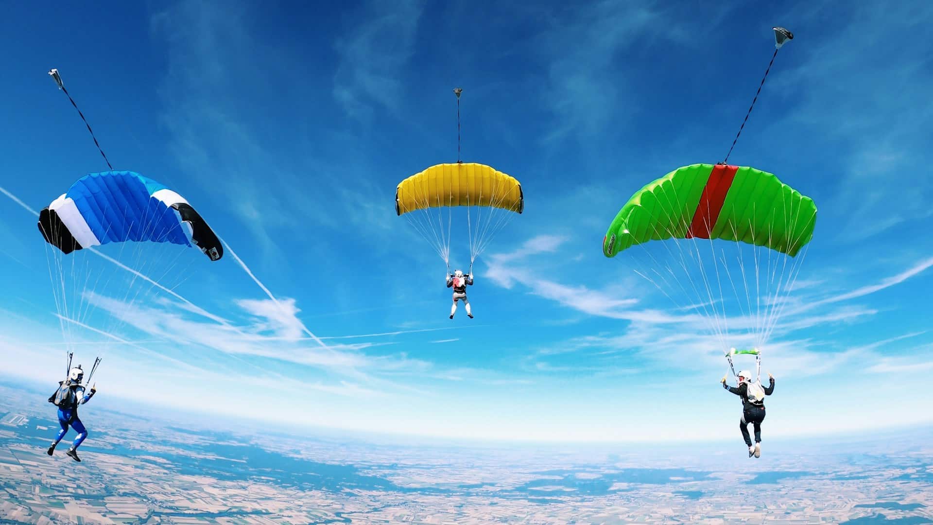 Image of three paragliders against a blue sky for marketing capabilities blog