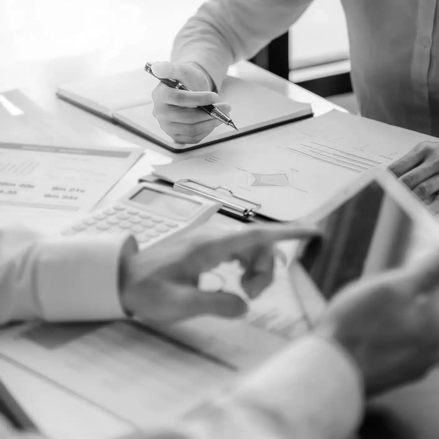 People writing on notepads